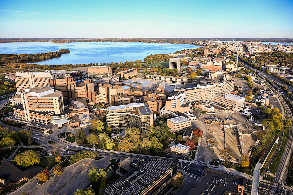 The medical complex on the west side of campus featuring UW Hospitals and Clinics is pictured in an aerial view of the University of Wisconsin–Madison campus during a sunny autumn day on Oct. 22, 2023. Clockwise from bottom, major campus buildings include the American Family Children's Hospital, the Wisconsin Institutes for Medical Research, the Waisman Center, the Health Sciences Learning Center, University Hospital, the Veterans Administration Hospital, construction site of the University Hospital expansion, and the UW Medical Foundation Centennial Building. The aerial photograph was made from a helicopter looking northeast with Lake Mendota to the left and the isthmus with the Wisconsin State Capitol in the background.