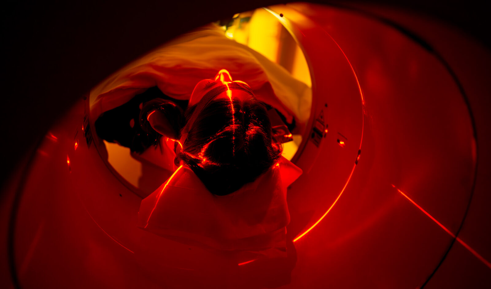 An individual enters a PET scan machine